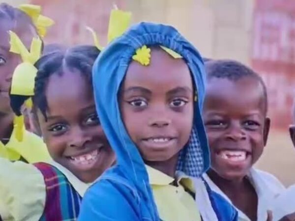 Children in school uniforms smiling